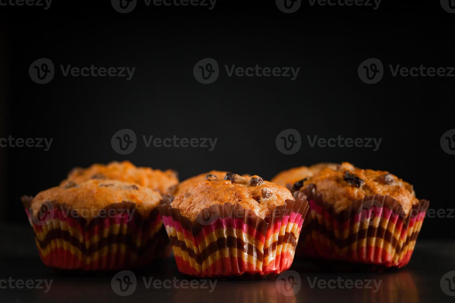 muffins op een zwarte achtergrond. zoete zelfgemaakte rozijnencakes. foto