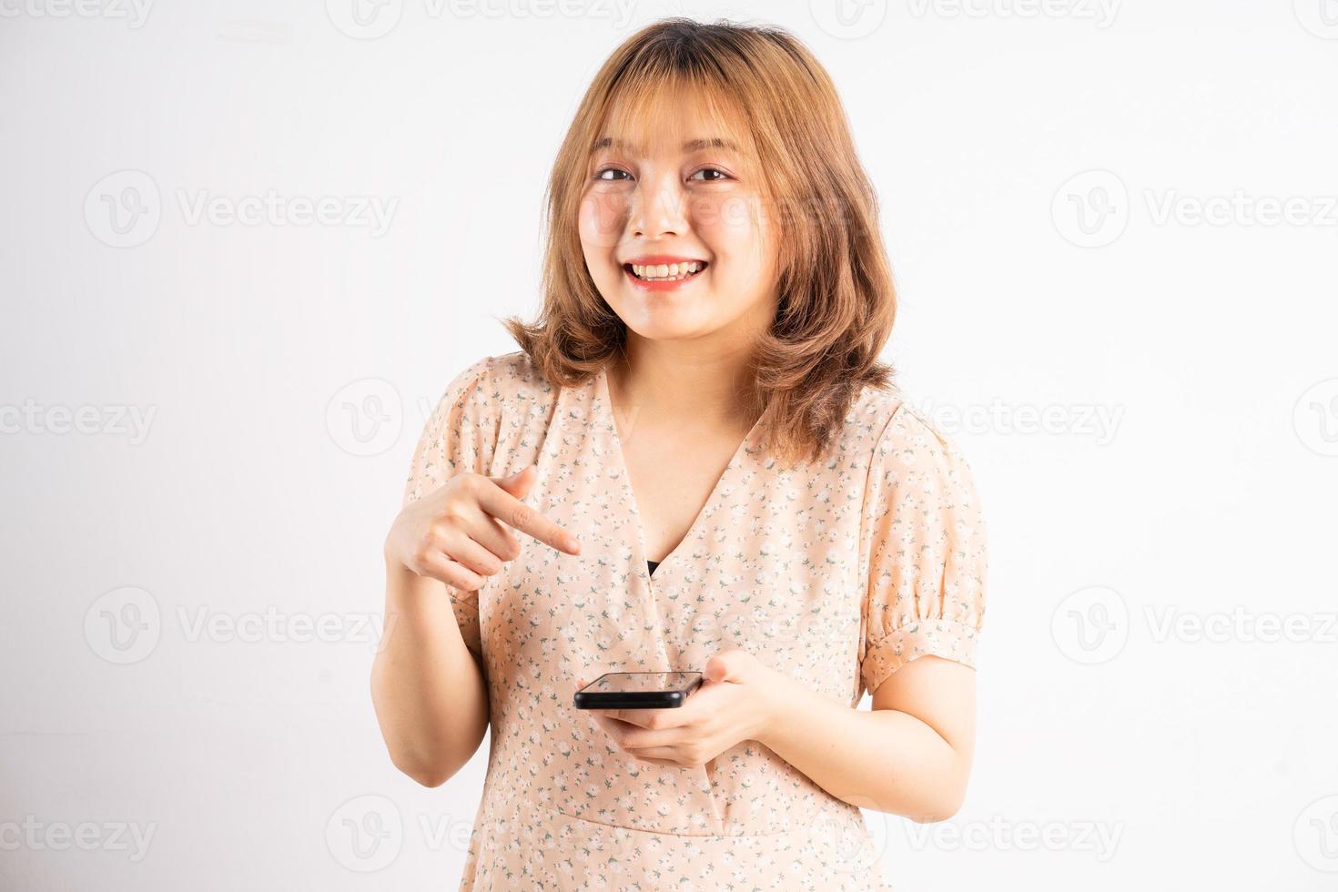 jong Aziatisch meisje met telefoon met uitdrukkingen, gebaren op de achtergrond foto