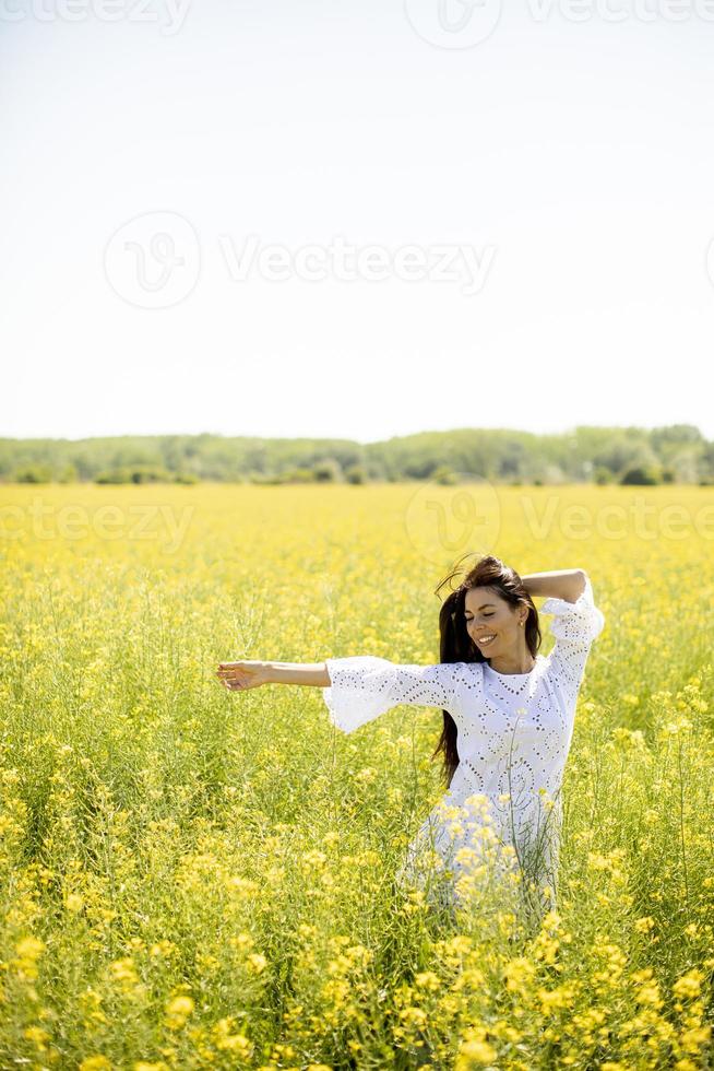 jonge vrouw in het koolzaadveld foto