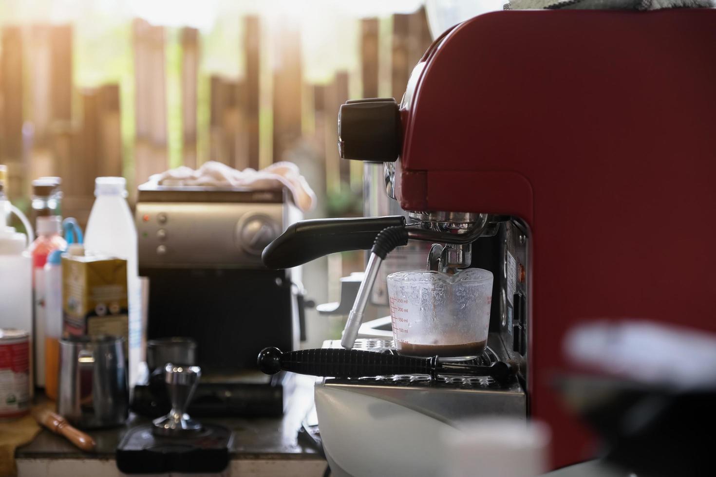 espresso gieten uit koffiezetapparaat. professioneel koffie zetten foto