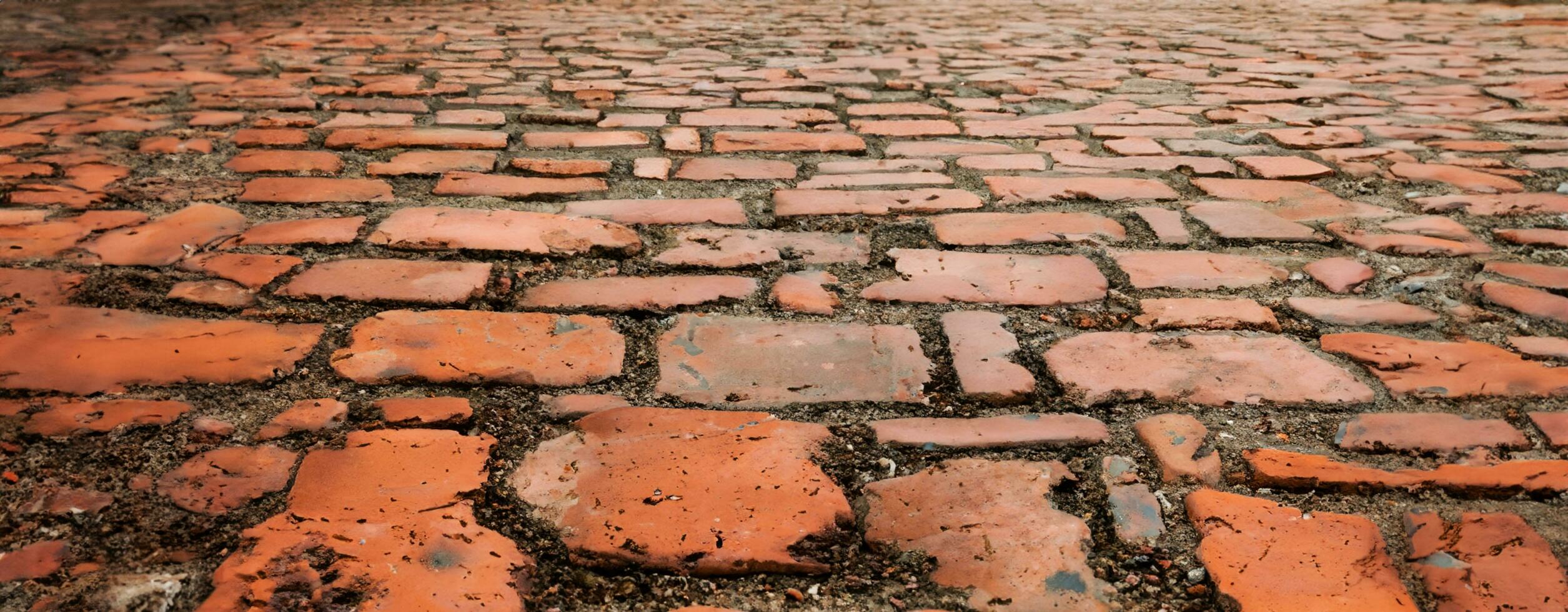 geplaveide bestrating dichtbij omhoog van de detail kasseien in een oud straat weg oppervlakte gemaakt van bruin rechthoekig stenen.oud weg graniet stenen 3d illustratie foto