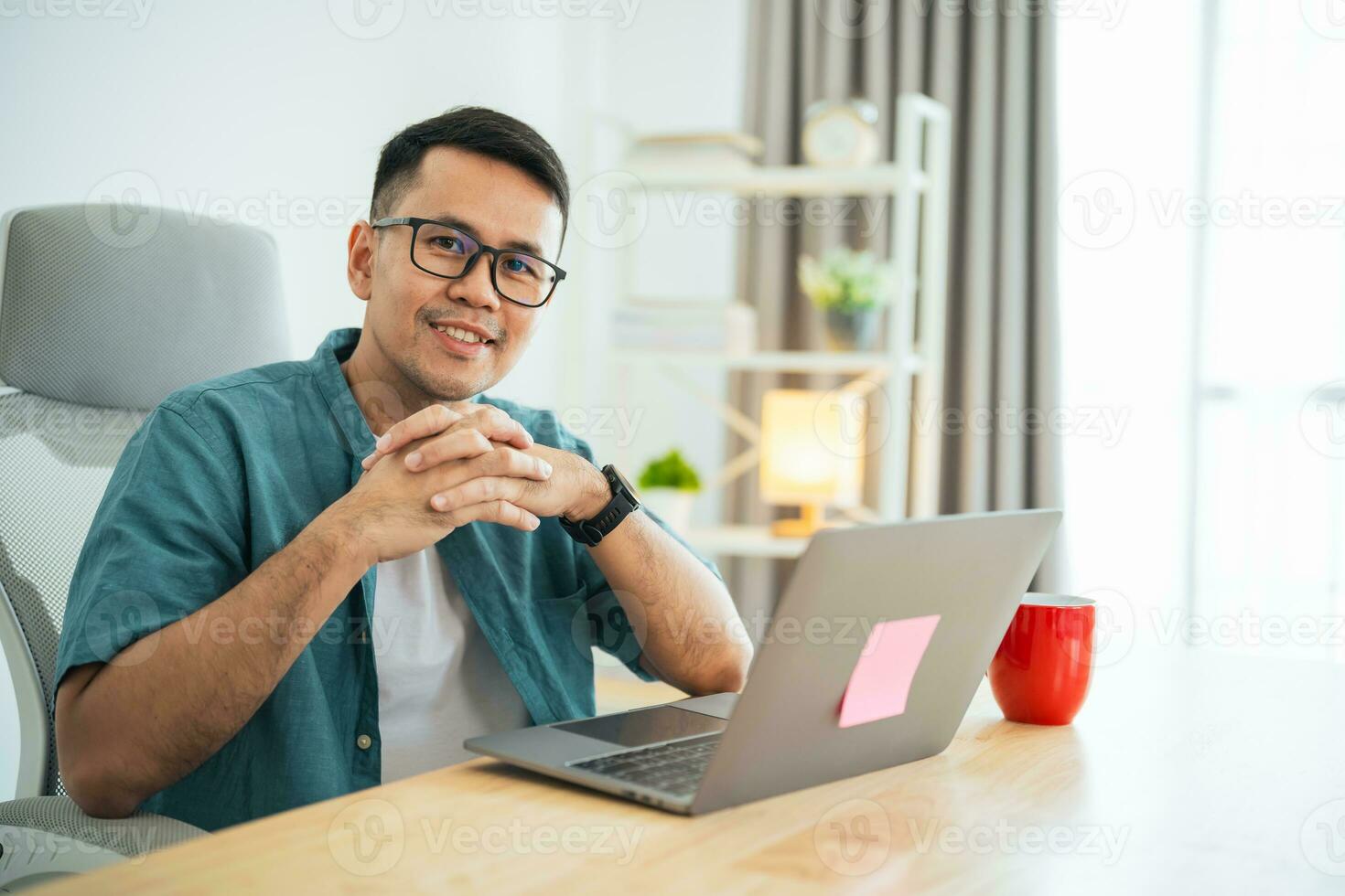 slim Aziatisch Mens glimlachen vervelend bril werken met computer laptop. concept werk het formulier huis, blijven Bij huis. freelance leven stijl, nieuw normaal sociaal afstand nemen levensstijl. werk het formulier overal concept. foto