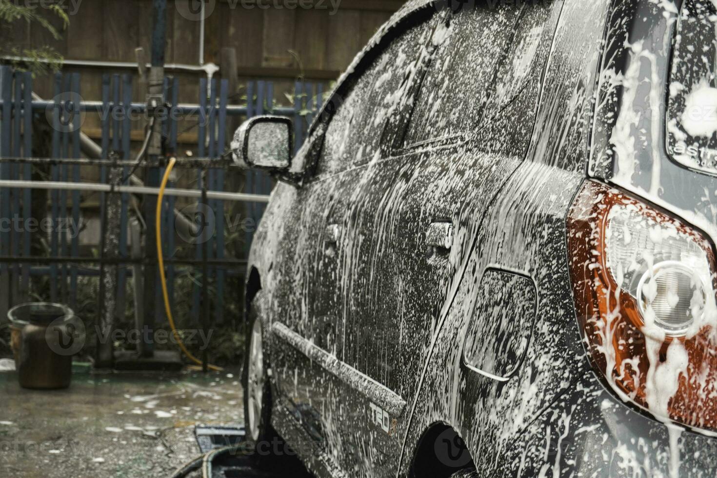 een grijs auto is wezen wassen in een Zelfbediening auto wassen station. foto
