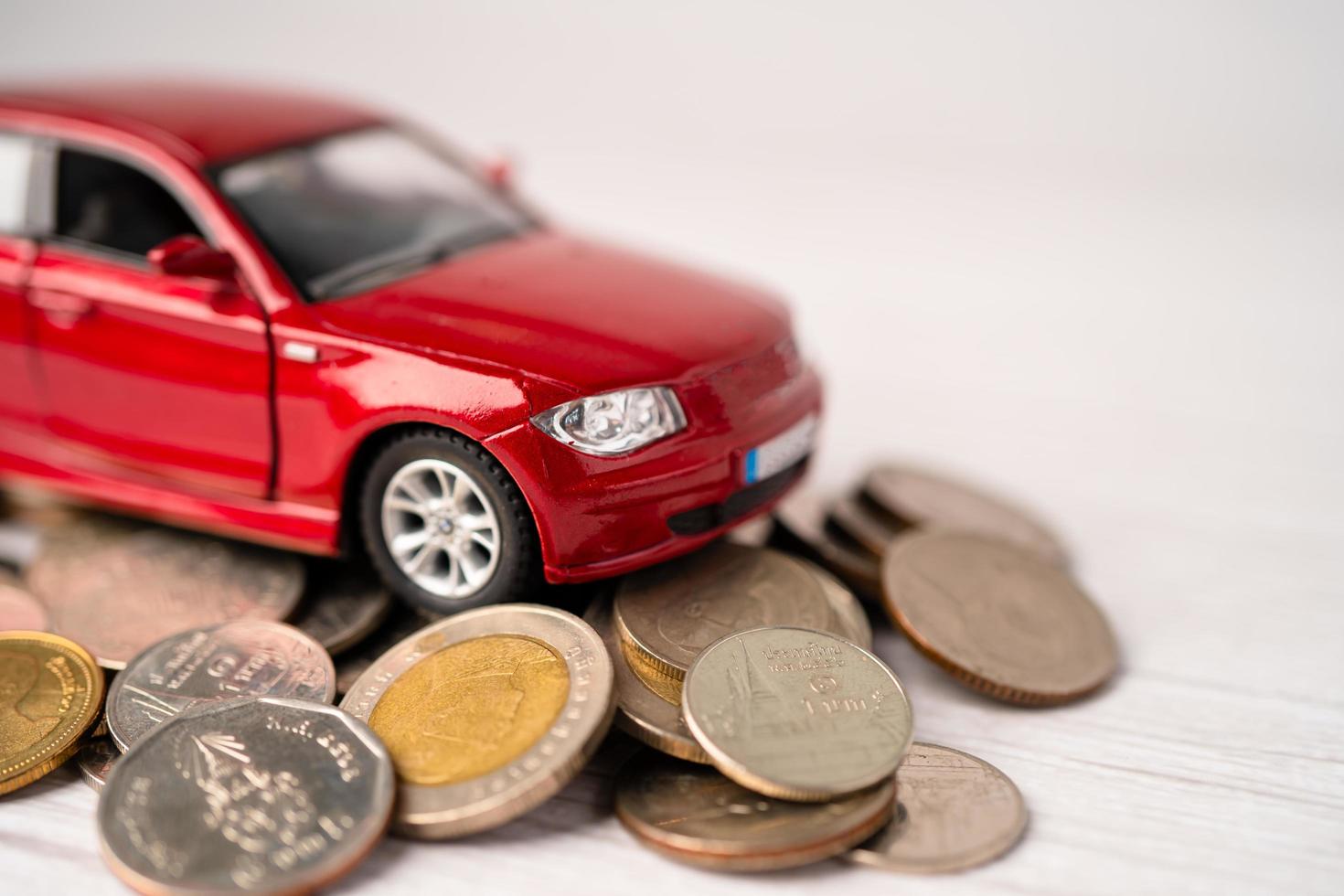 auto op muntenachtergrond, autolening, financiën, geld besparen, verzekeringen en leasetijdconcepten. foto
