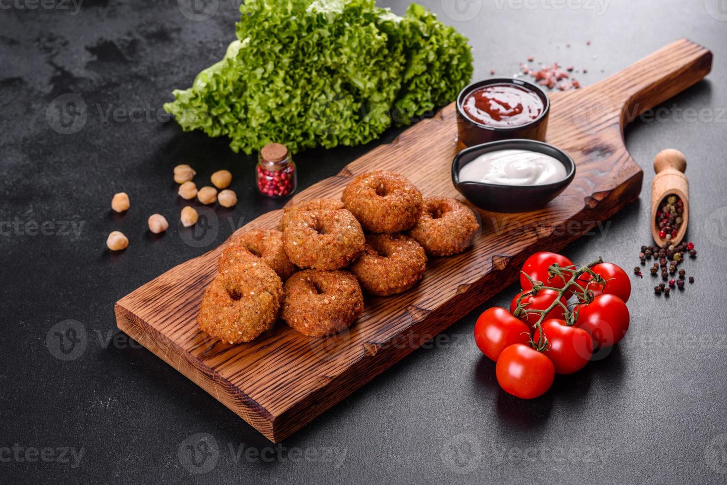 mooie heerlijke verse kikkererwten falafel met sauzen op een betonnen ondergrond foto