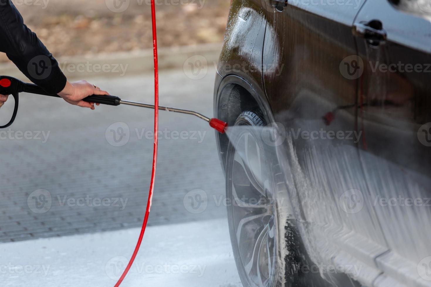 auto zonder aanraking wassen self-service. wassen met water en schuim. foto