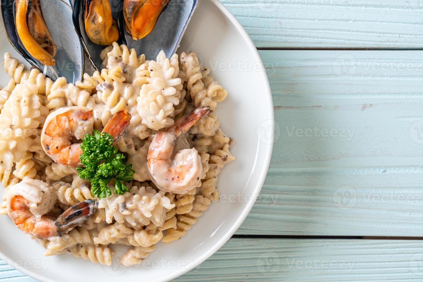 spiraalvormige pasta-champignonroomsaus met zeevruchten - italiaanse eetstijl foto