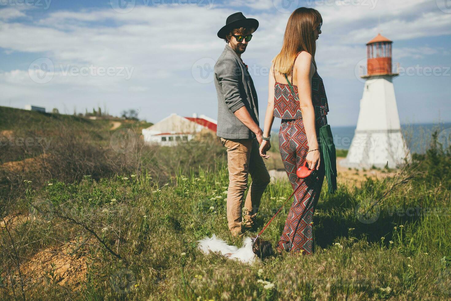 visie van terug Aan jong elegant hipster paar in liefde wandelen met hond in platteland foto