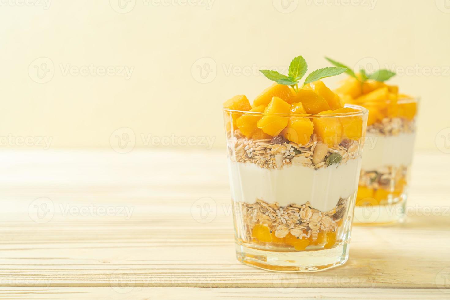 verse mangoyoghurt met muesli in glas - gezonde voedingsstijl foto