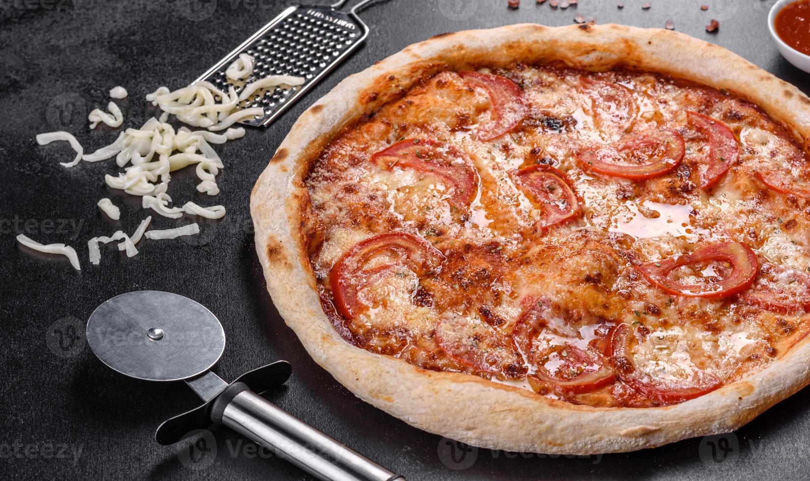 verse heerlijke Italiaanse pizza met champignons en tomaten op een donkere betonnen ondergrond concrete foto