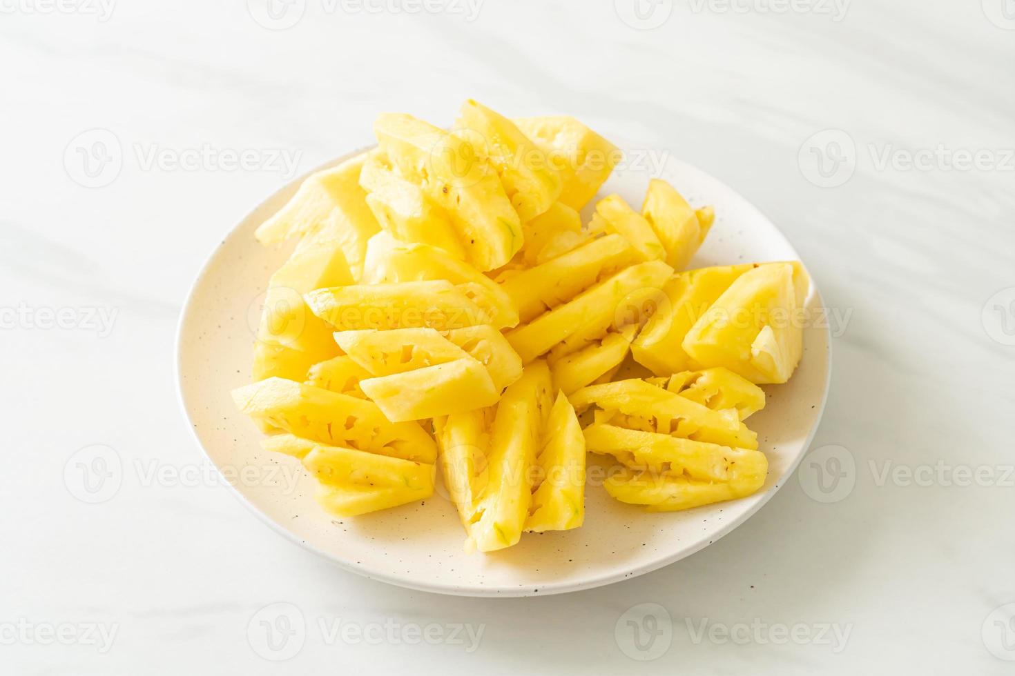 verse ananas gesneden op witte plaat foto