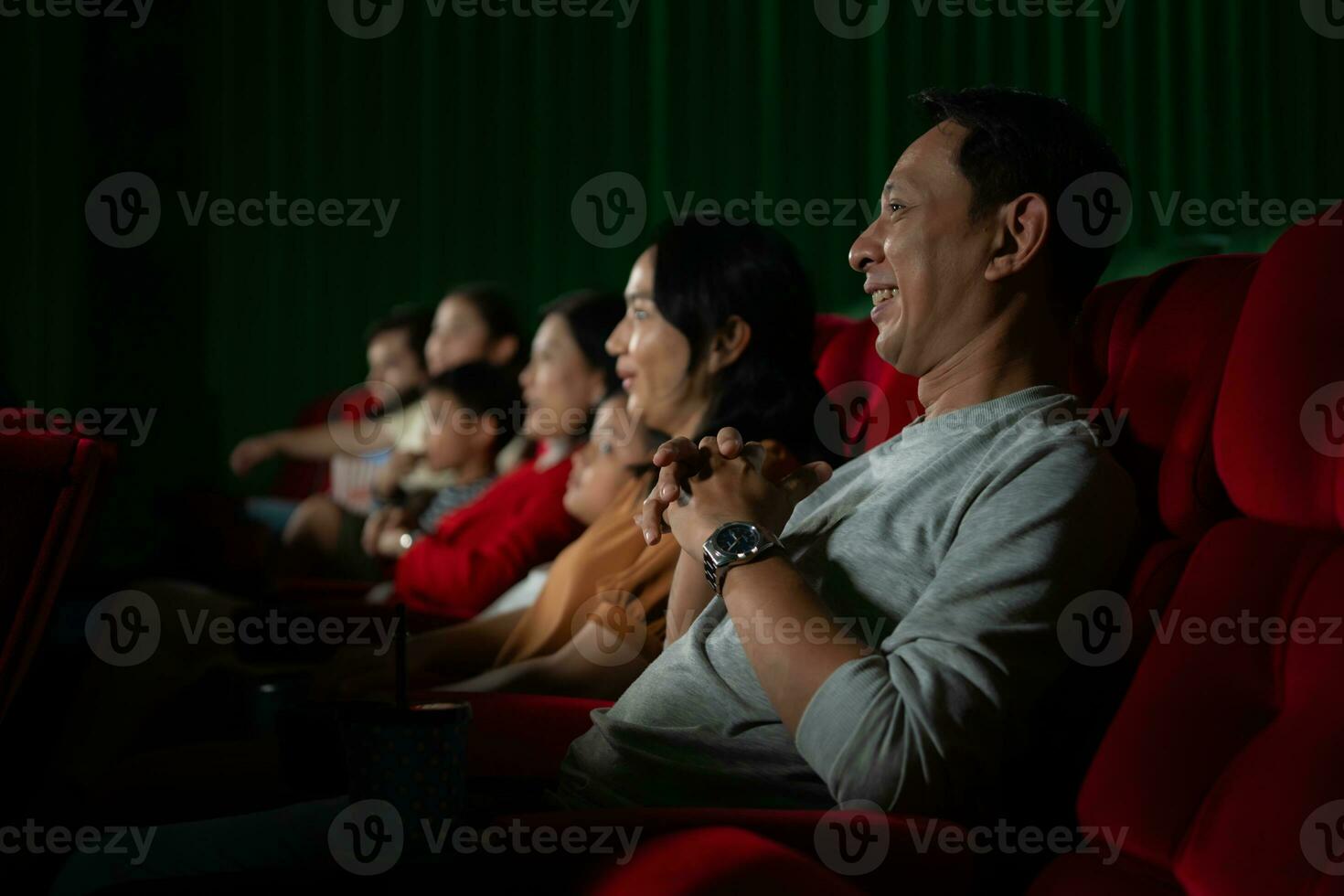 Aziatisch moeder en dochter aan het kijken film in bioscoop. familie tijd concept. foto