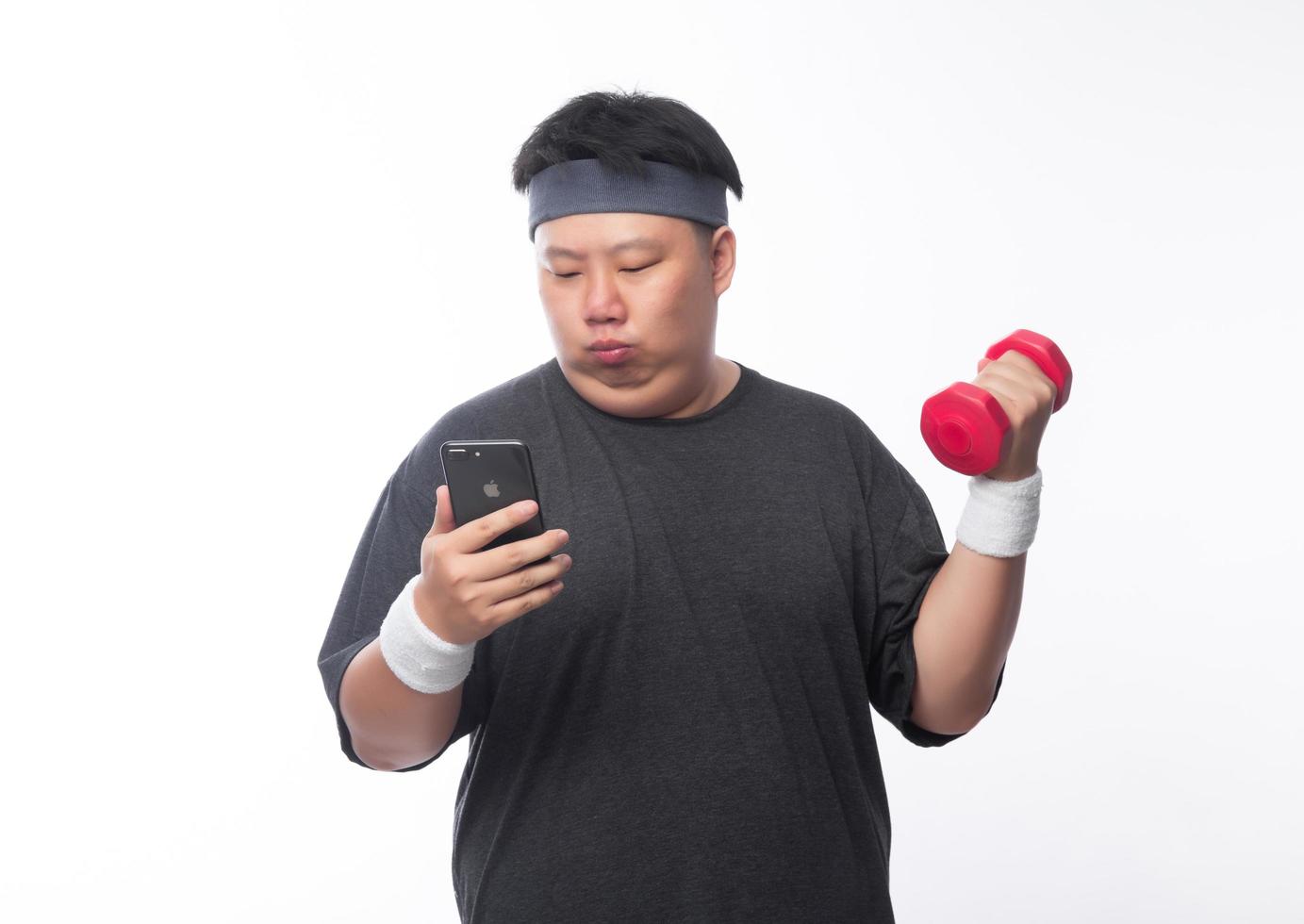 jonge aziatische grappige dikke sportman oefening met halter foto