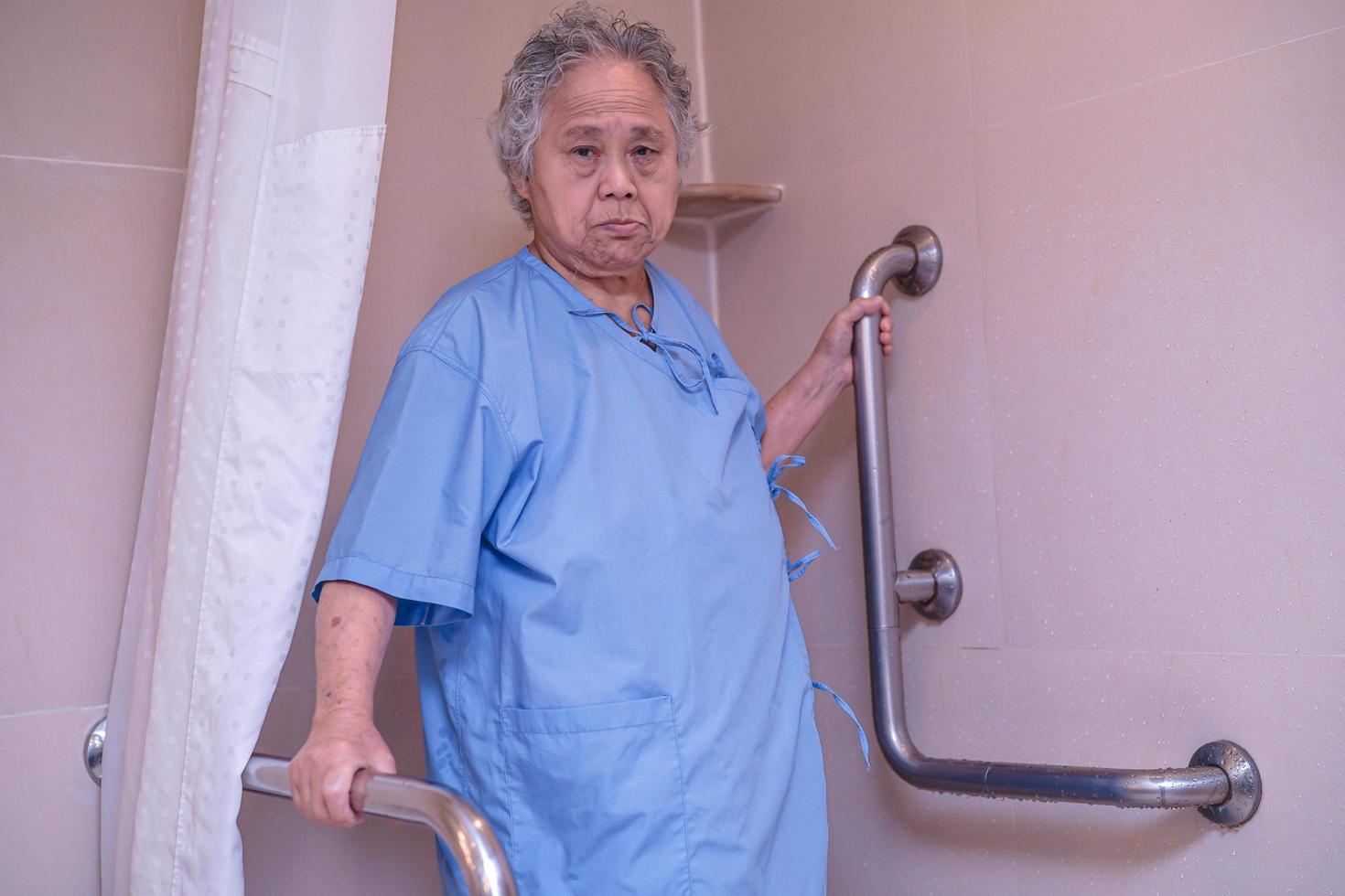 Aziatische senior of oudere oude dame vrouw patiënt gebruik toilet badkamer handvat beveiliging in verpleegafdeling ziekenhuis, gezond sterk medisch concept. foto