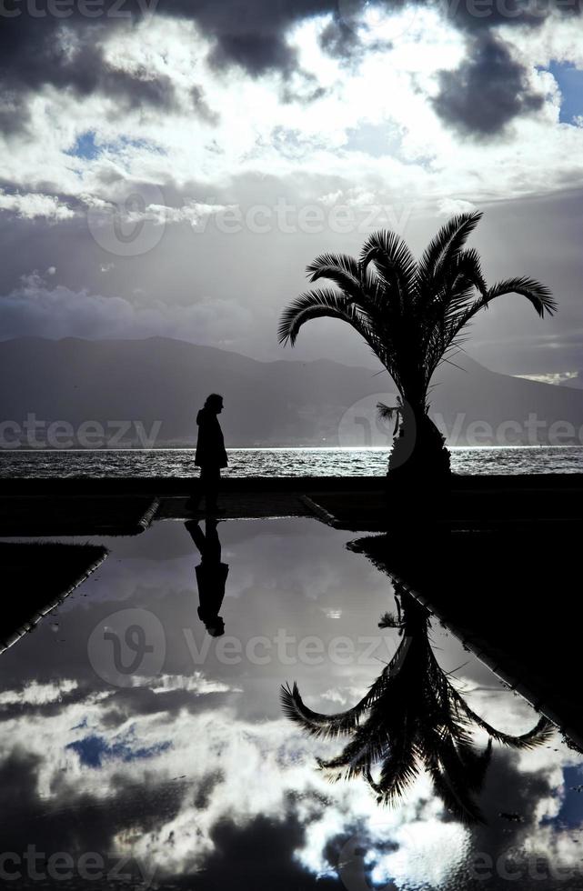 uitzicht op zee en een silhouet van een man op het water foto