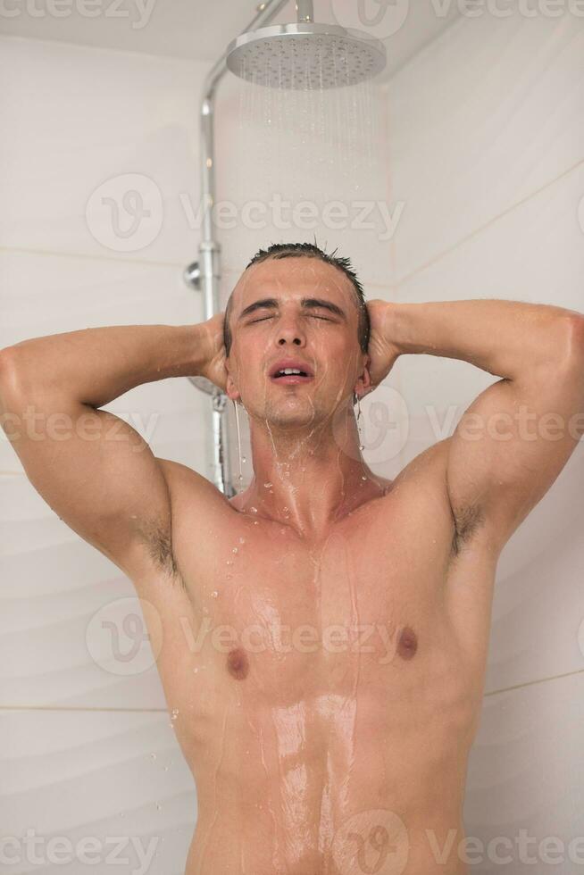 Mens nemen douche in bad foto