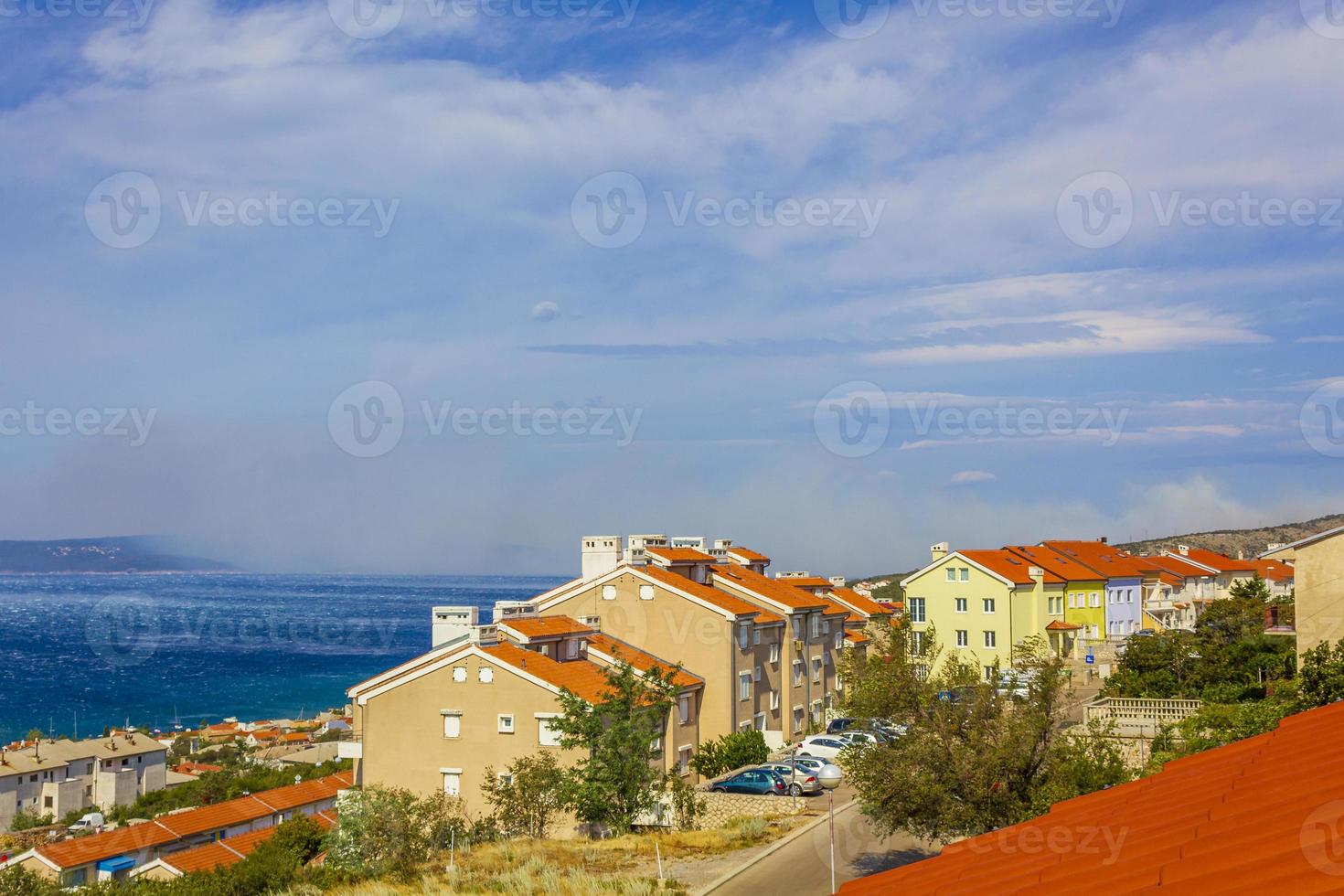 novi vinodolski in kroatië op een zonnige dag met rook van de bosbrand aan de horizon foto