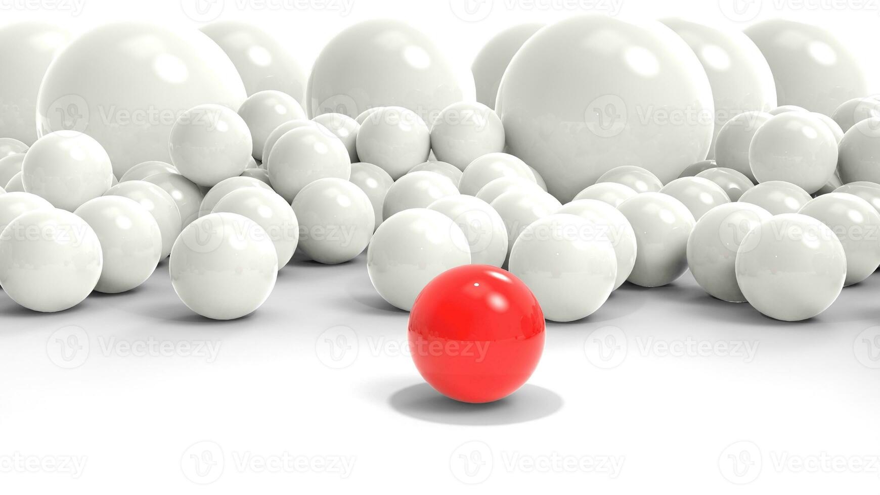 rood bal staat uit en in voorkant van bundel van algemeen wit ballen foto