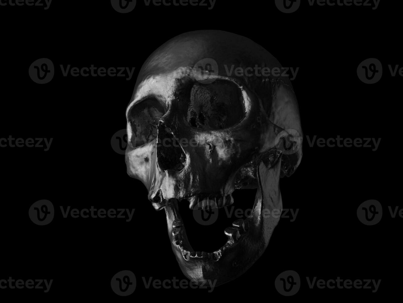 olie zwart menselijk schedel met Open kaak en missend tanden foto