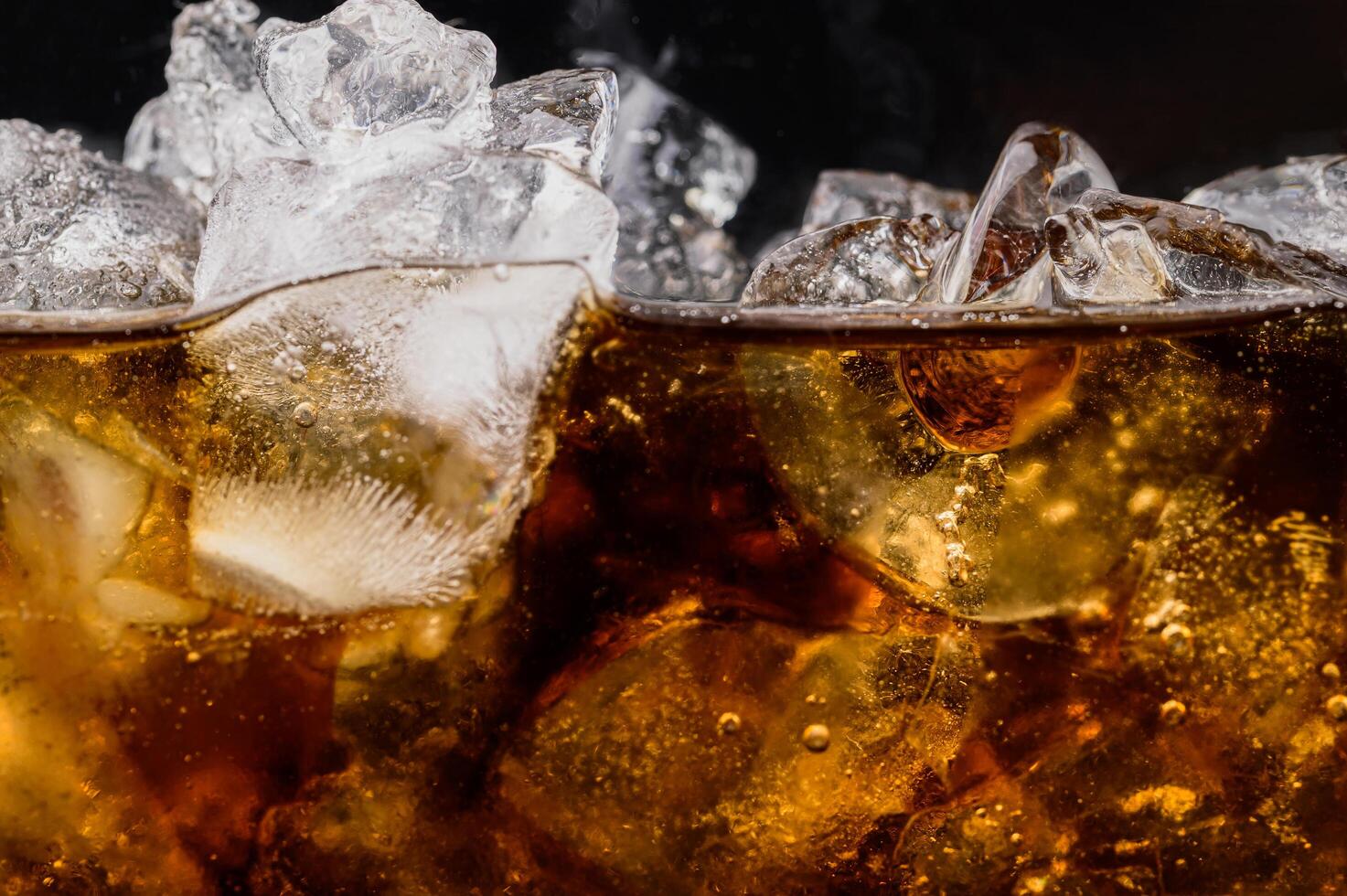 cola in glas met heldere ijsblokjes foto