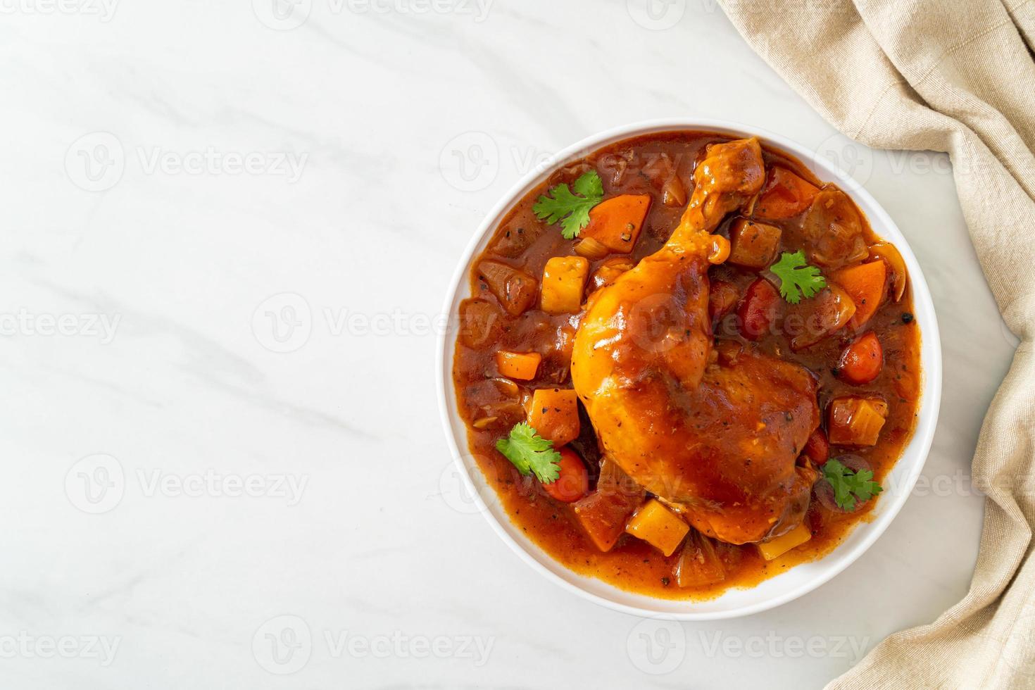 zelfgemaakte kipstoofpot met tomaten, uien, wortel en aardappelen op bord foto