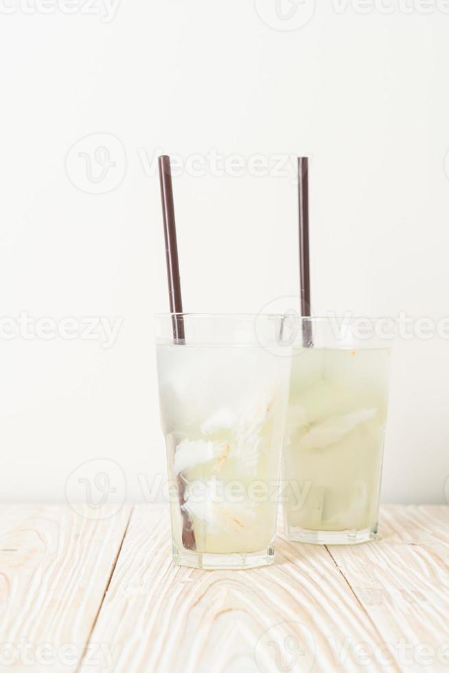 kokoswater of kokossap in glas met ijsblokjes foto