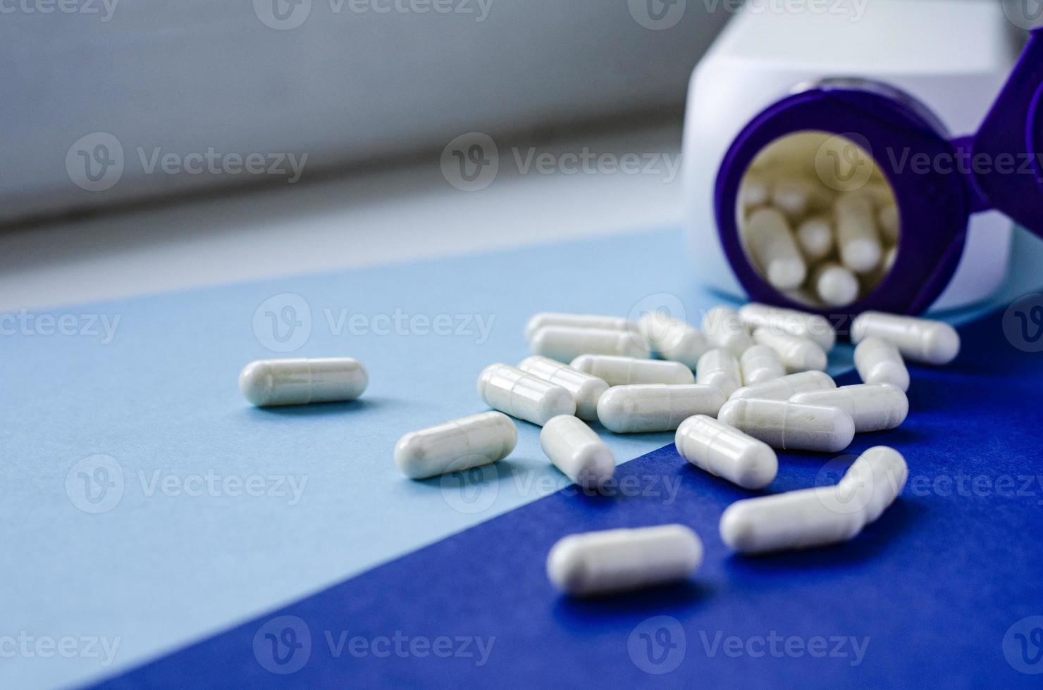 verschillende farmaceutische pillen en capsules uit een pot. foto