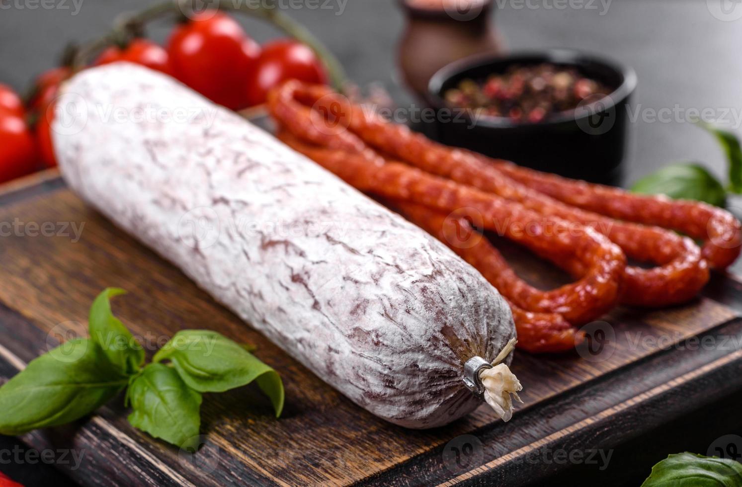 Spaanse gedroogde worstsalami op een donkere betonnen ondergrond foto