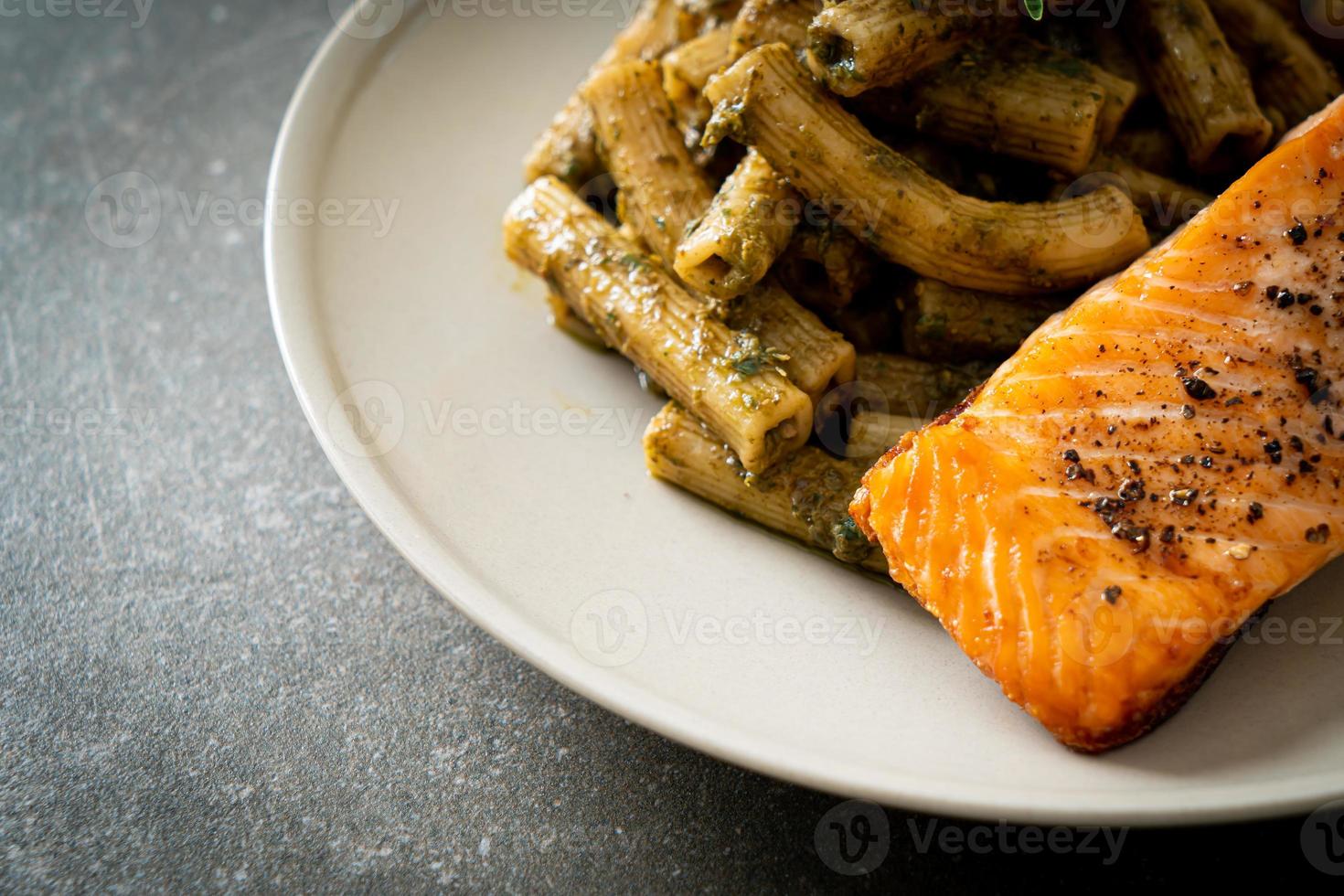 pesto quadrotto penne pasta met gegrilde zalmfilet steak foto