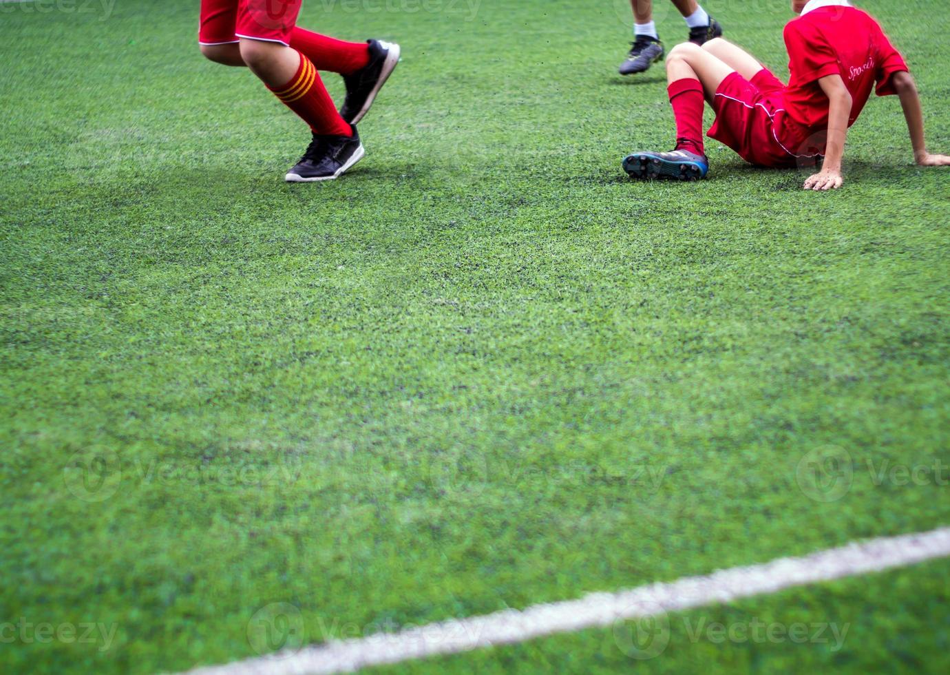 de voetballers strijden op het kunstgrasveld van school foto