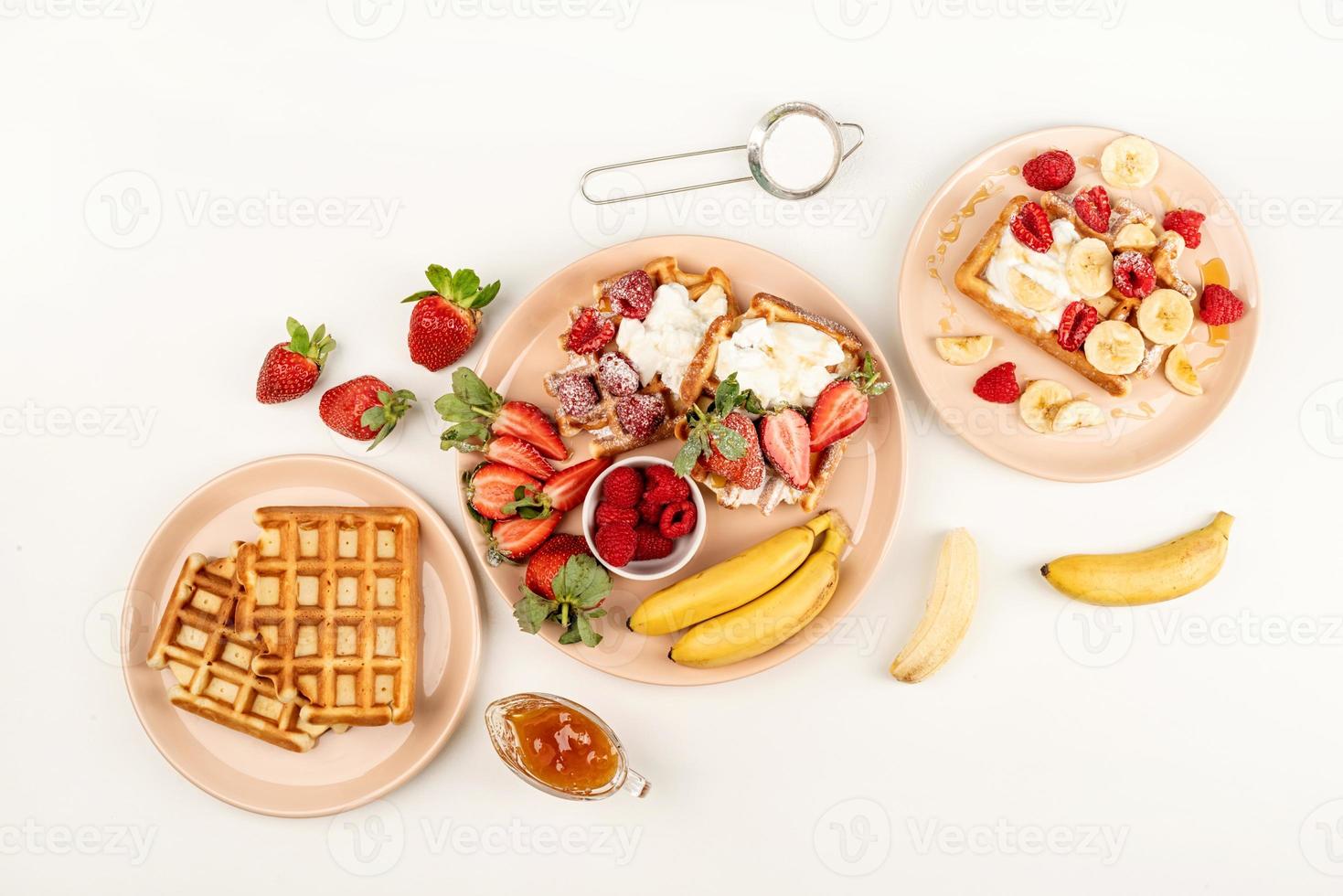 wafels met fruit en bessen, room en honing in een bord foto