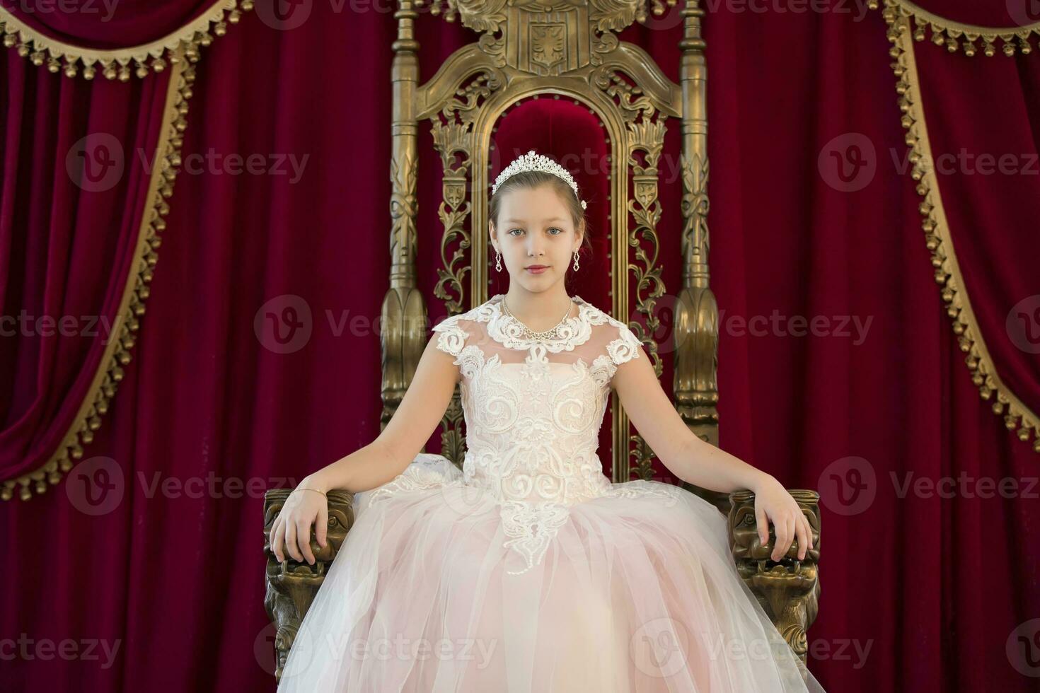 tiener meisje slim in rood luxe Koninklijk fauteuil. meisje prinses.koningin in een rood stoel.luxe jong dame in een wit jurk in een oud rood fauteuil foto