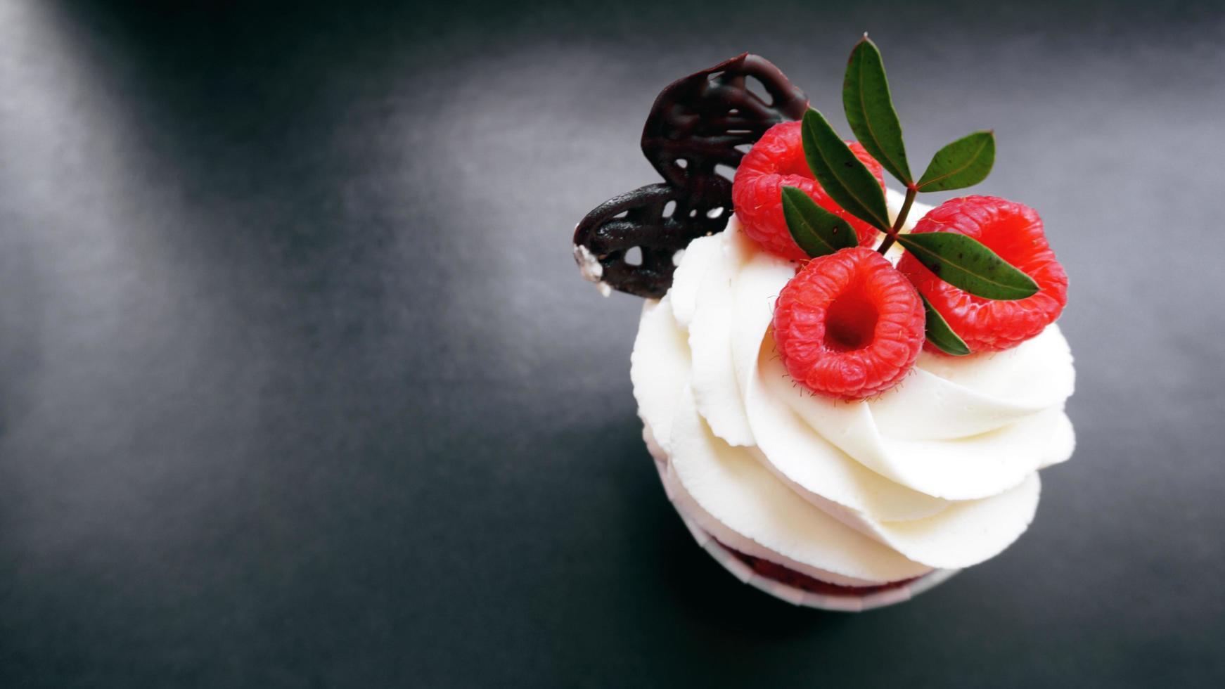 heerlijke frambozen cupcakes op donkere achtergrond foto