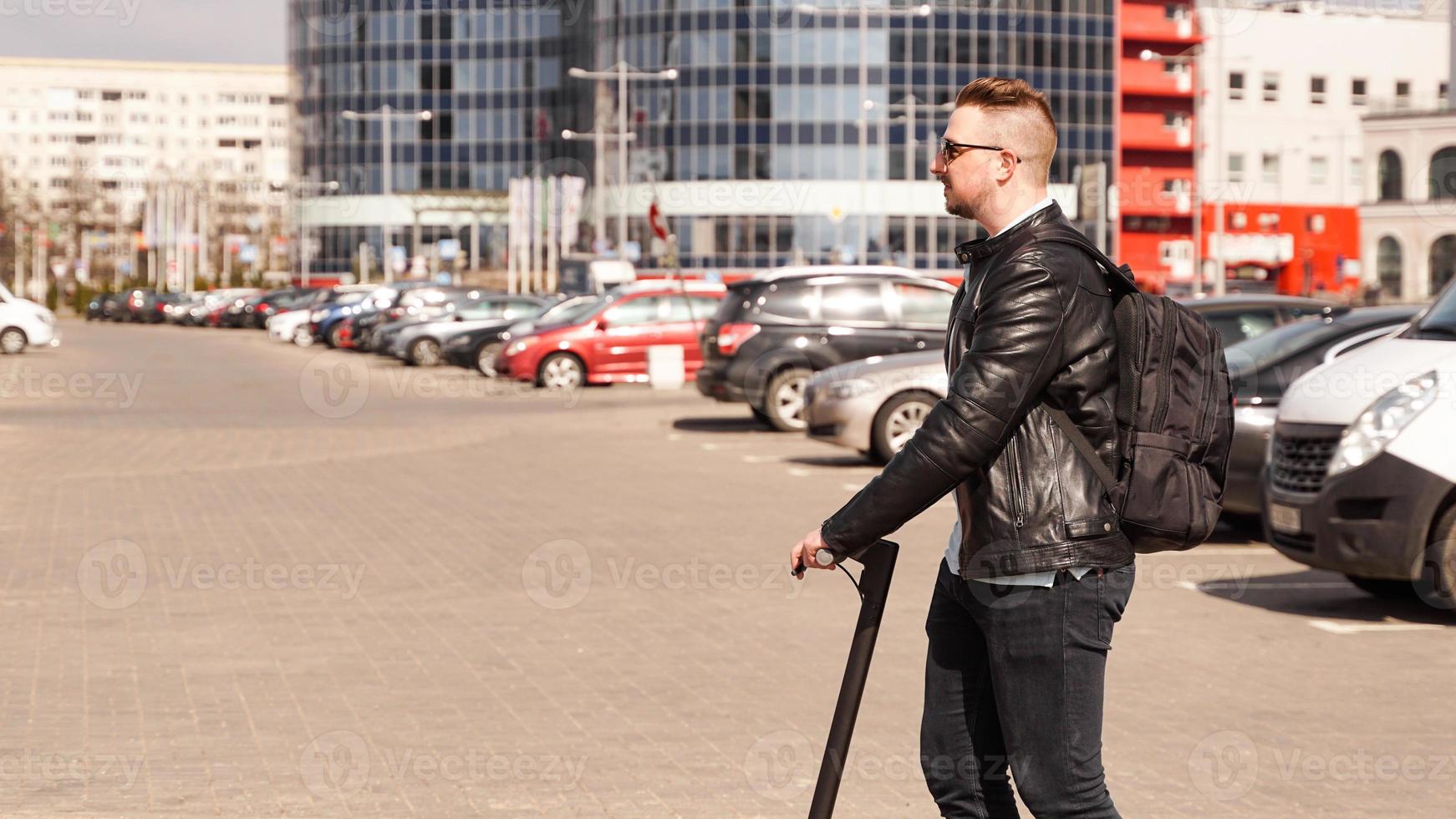 moderne man rijdt op een elektrische scooter in de stad foto