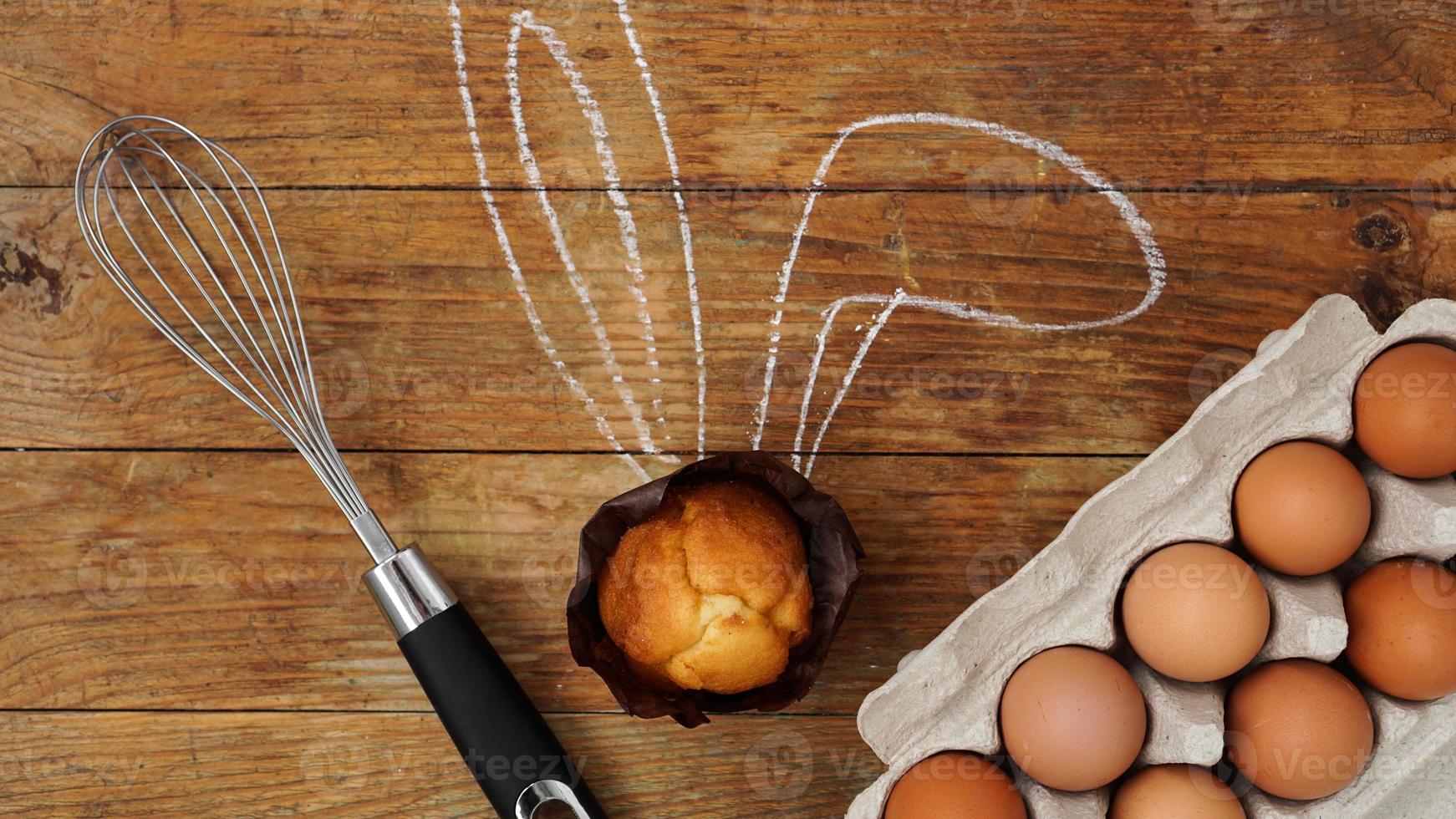 zelfgemaakte muffin met geschilderde konijnenoren. muffin en eieren op een houten foto