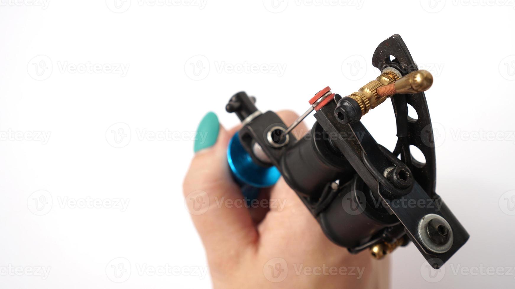 tattoo machine op tattoo artiest hand op witte achtergrond foto