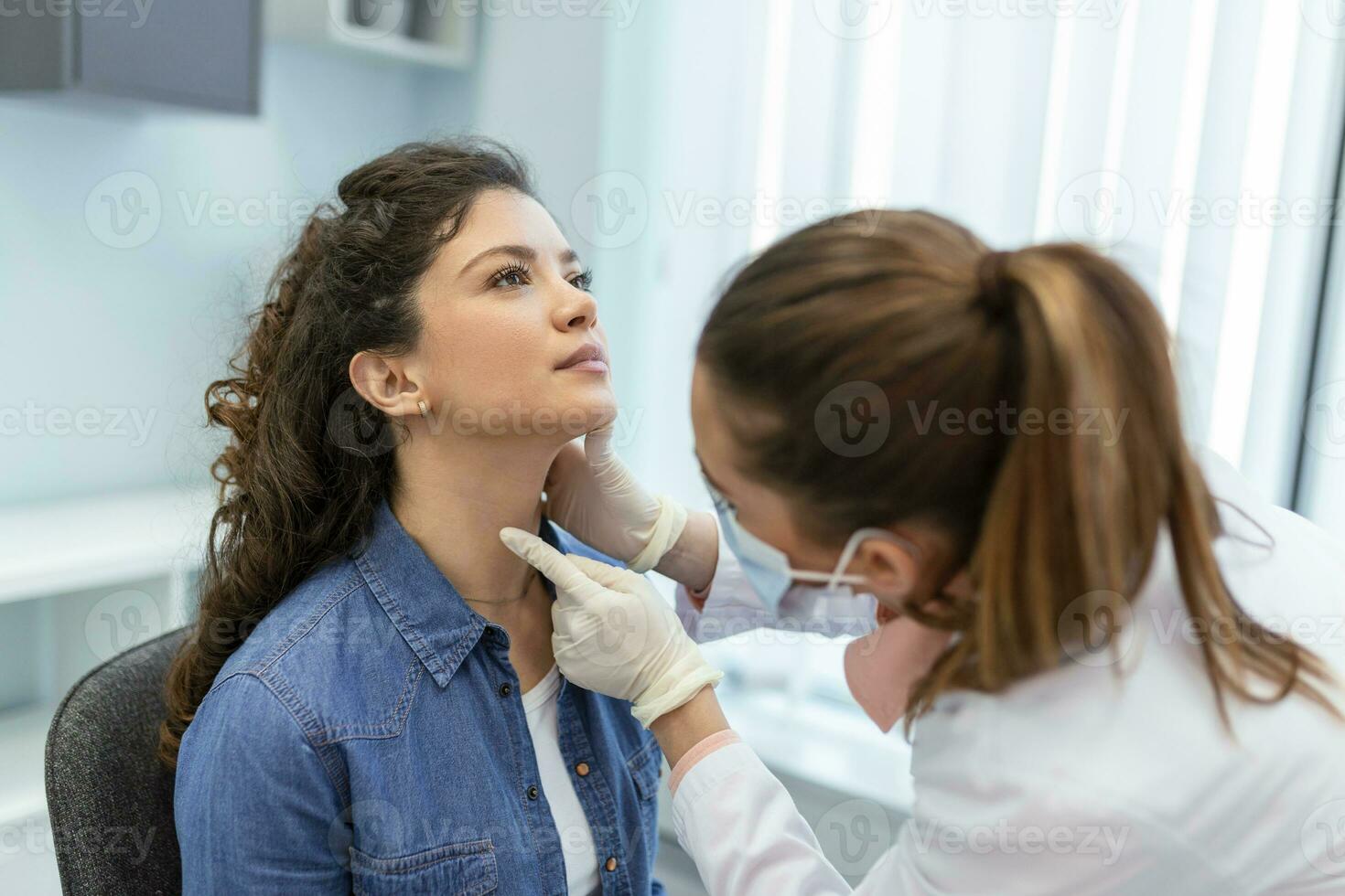 geneesmiddel, gezondheidszorg en medisch tentamen concept - dokter of verpleegster controle patiënten amandelen Bij ziekenhuis. endocrinoloog onderzoeken keel van jong vrouw in kliniek foto