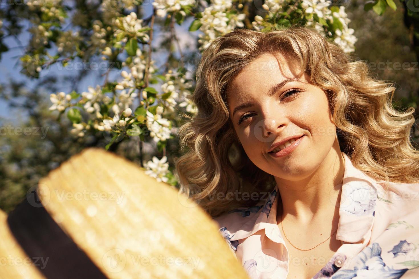 lachende zomervrouw met strohoed in park foto