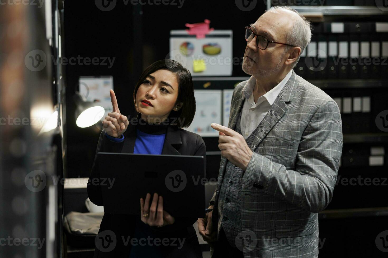 samenwerken professioneel accounting ouderen zakenman en Aziatisch collega op zoek voor boekhouding bureaucratisch papierwerk Aan het dossier kabinet planken. team leidinggevenden in opslagruimte repository kantoor kamer foto