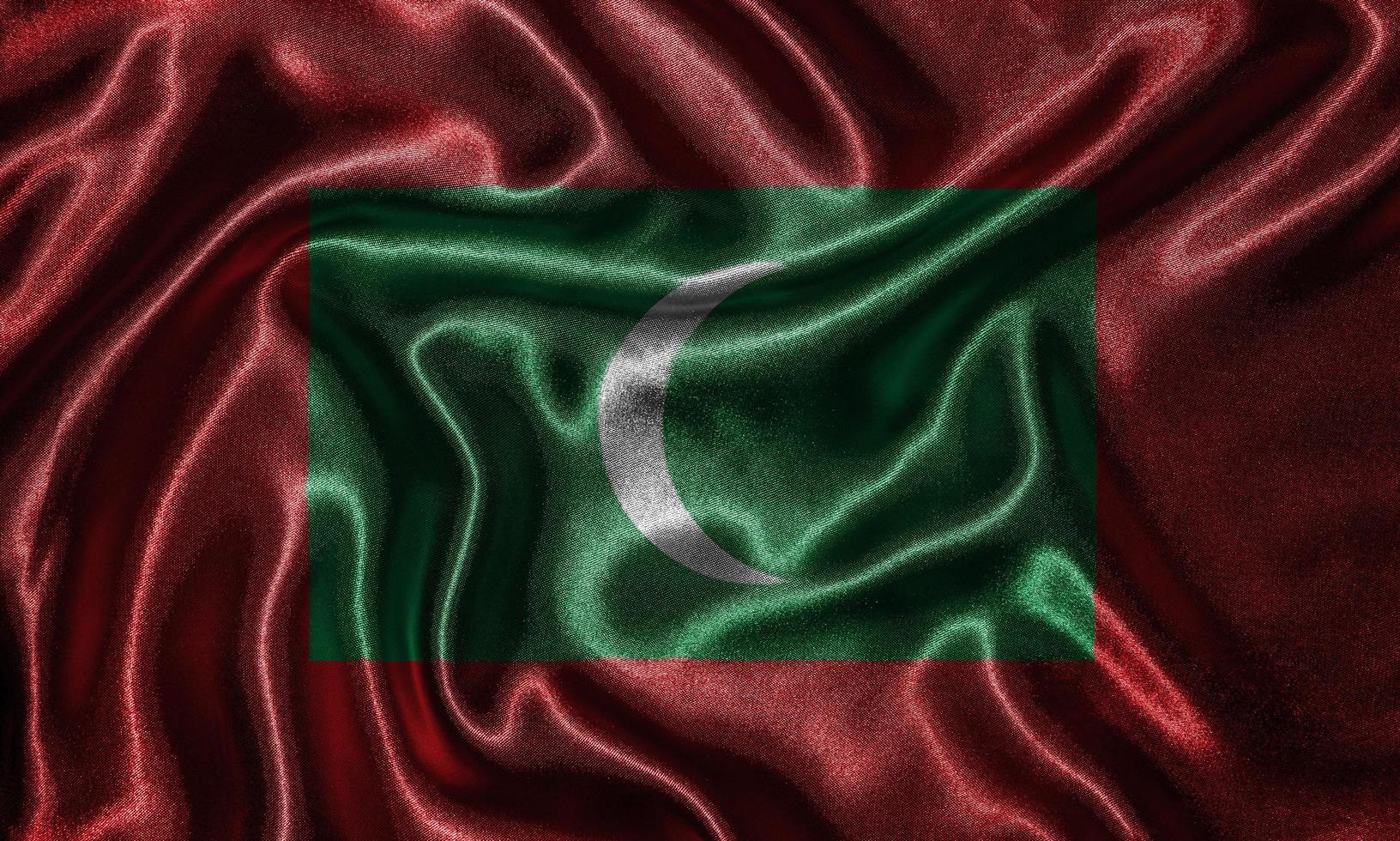behang met de vlag van de Malediven en de wapperende vlag per stof. foto