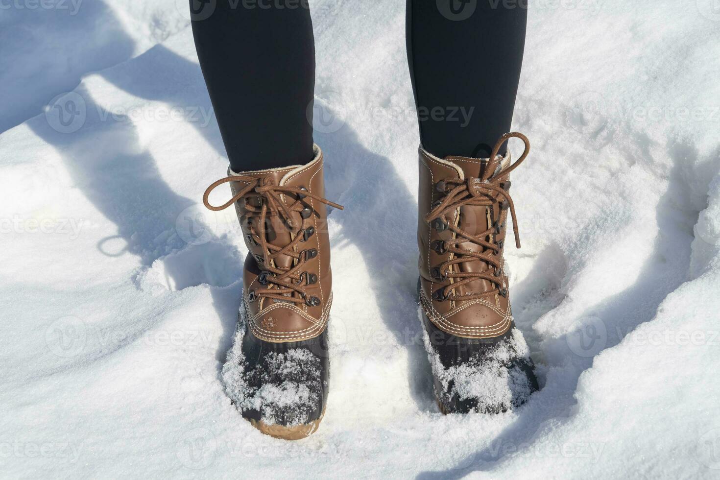 laarzen van een vrouw staand in de sneeuw foto