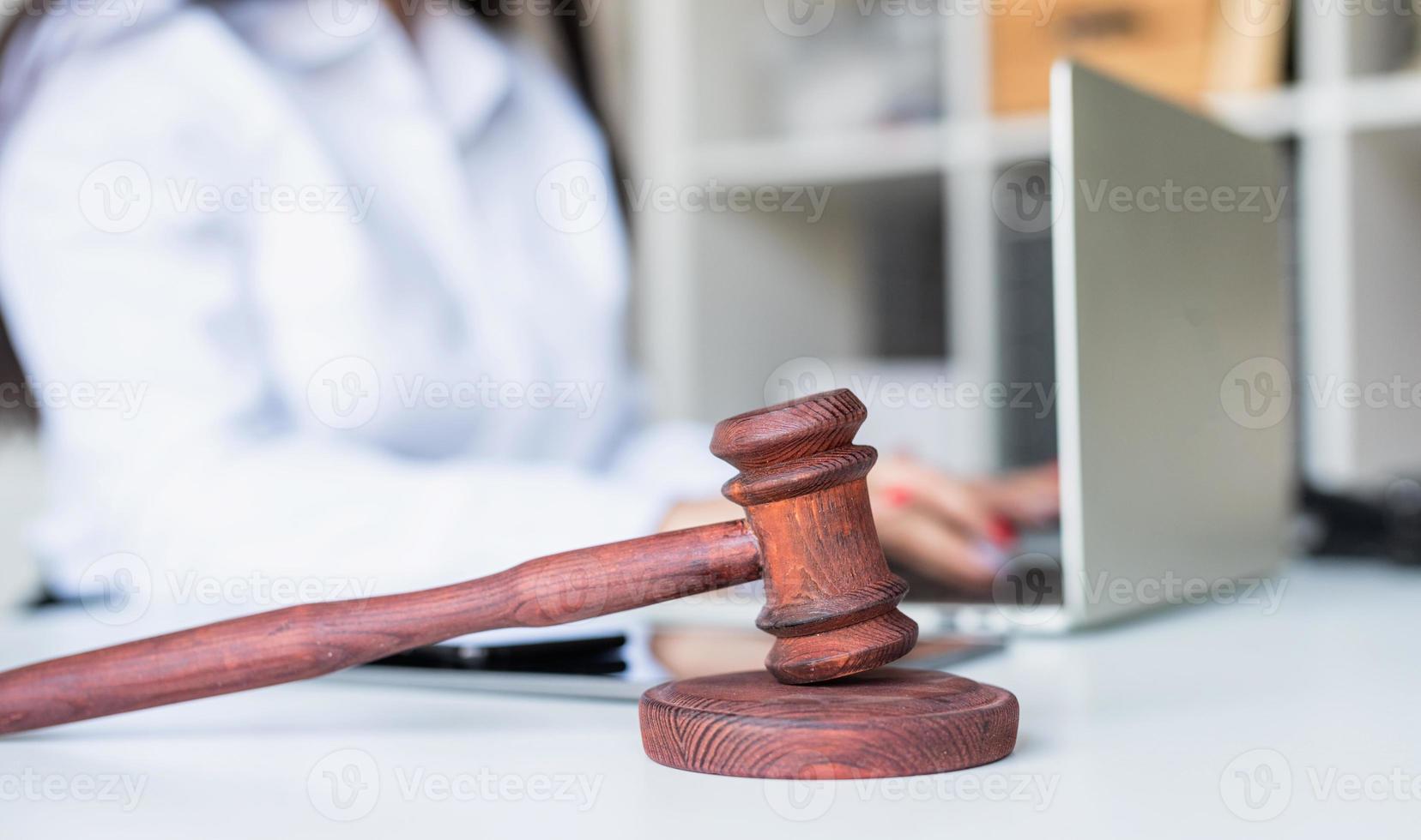 close-up van houten hamer, advocaat die op de laptop werkt foto