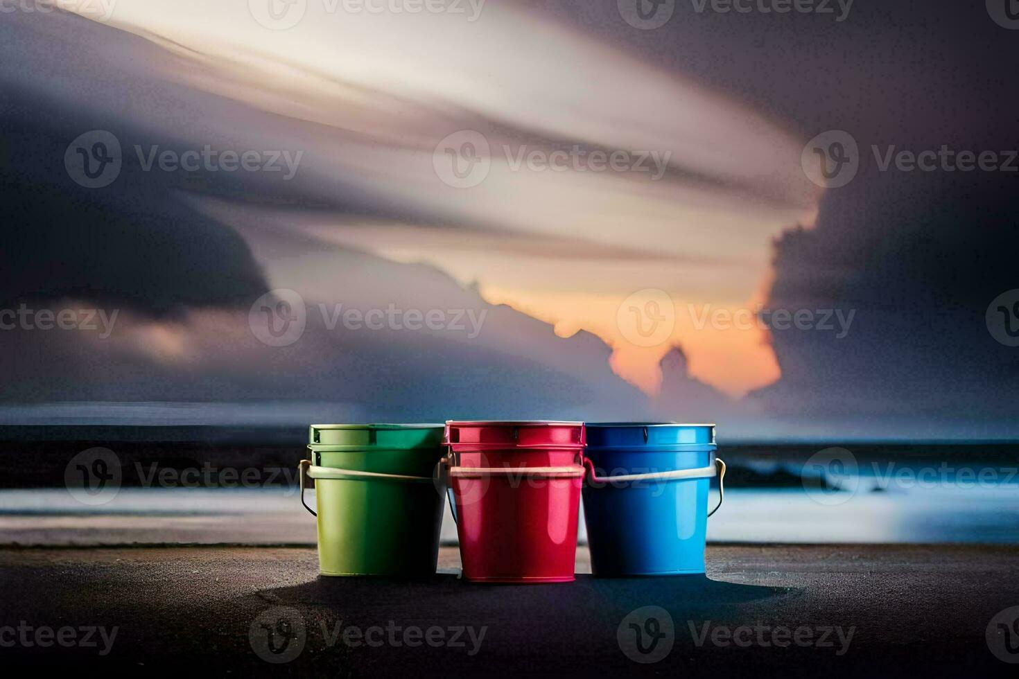 drie kleurrijk emmers zitten Aan de strand Bij zonsondergang. ai-gegenereerd foto