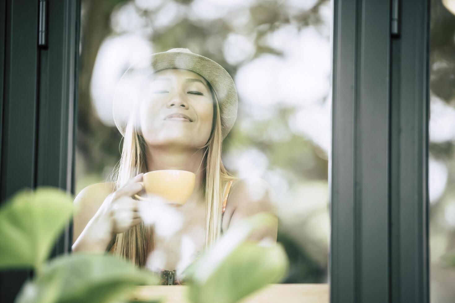 gelukkige jonge vrouw met latte koffie in de ochtend foto