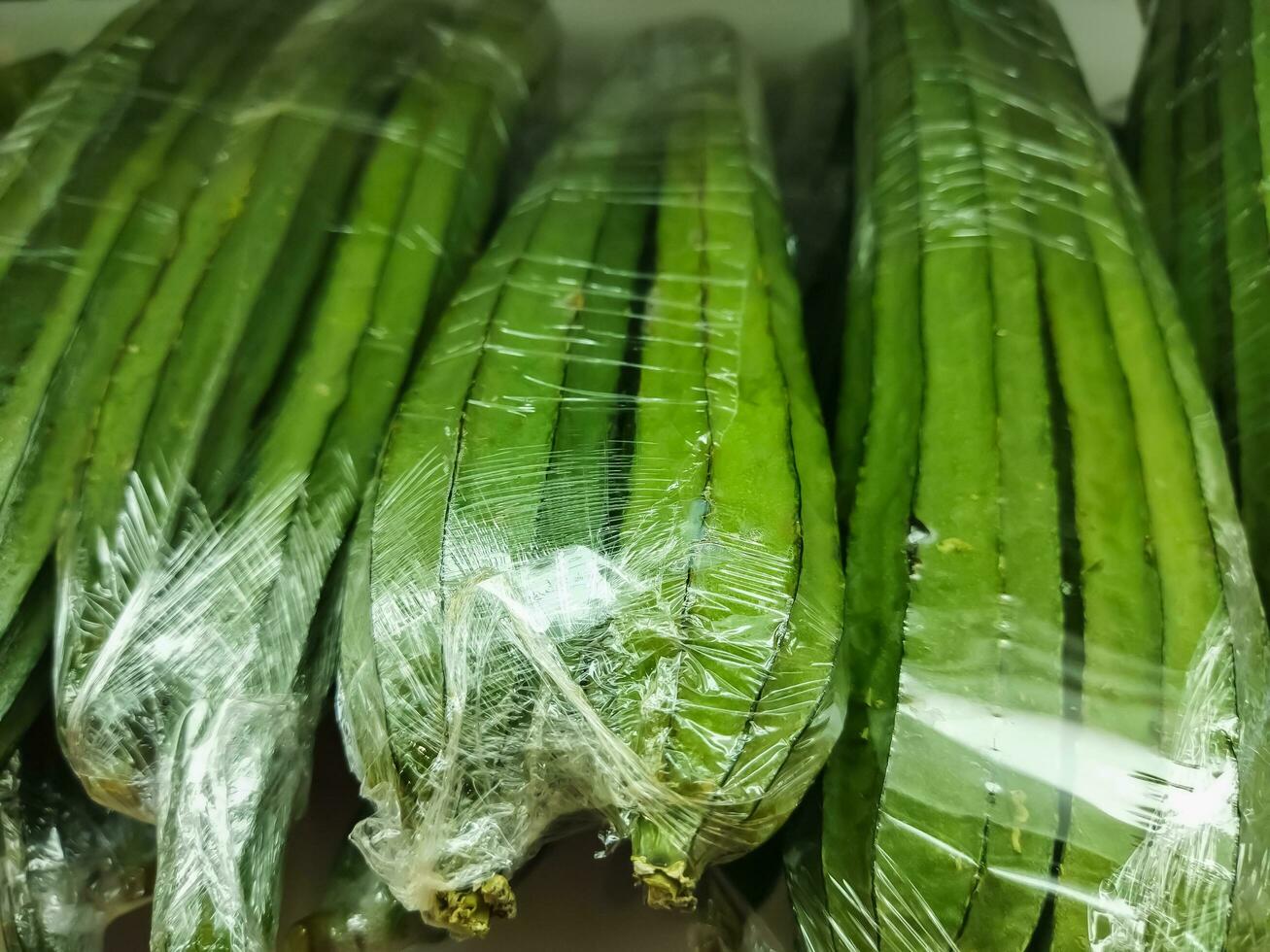 groen slang luffa of luffa acutangula roxb. een veel van vers luffa cilindrisch, spits toelopend kalebas luffa of hoekig loofah Aan uitverkoop in groenten staan Scherm in de supermarkt. foto