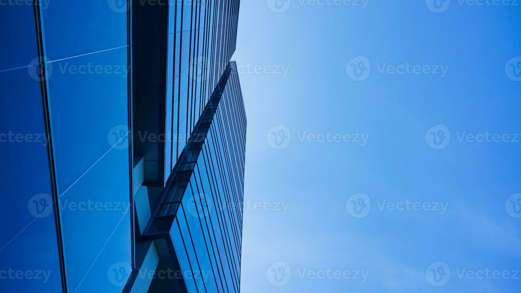 bodem visie blauw bril gebouw met lucht en wolk achtergrond. wolkenkrabber, visie van modern bedrijf gebouw. mockup modern blauw bril gebouw landschap. op zoek omhoog perspectief. kopiëren ruimte foto