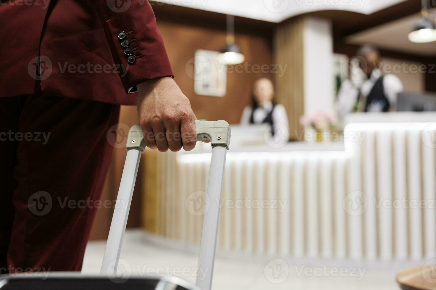 wit halsband arbeider met bagage aankomen Bij hotel ontvangst lobby, voorbereidingen treffen naar zien kamer reservering. jong volwassen op reis Aan bedrijf vergaderingen, draag- koffer internationaal. dichtbij omhoog. foto