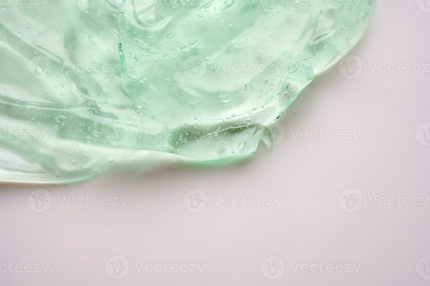 transparant Doorzichtig groen vloeistof serum gel kunstmatig structuur achtergrond foto