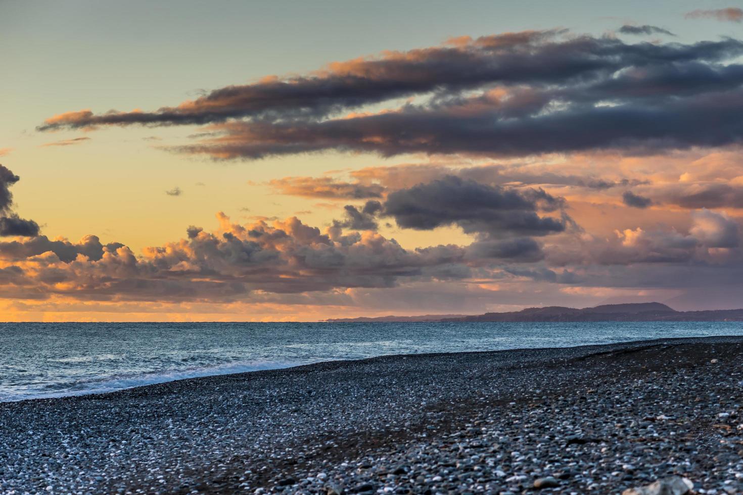 kleurrijke wolken bij zonsondergang en de zee foto