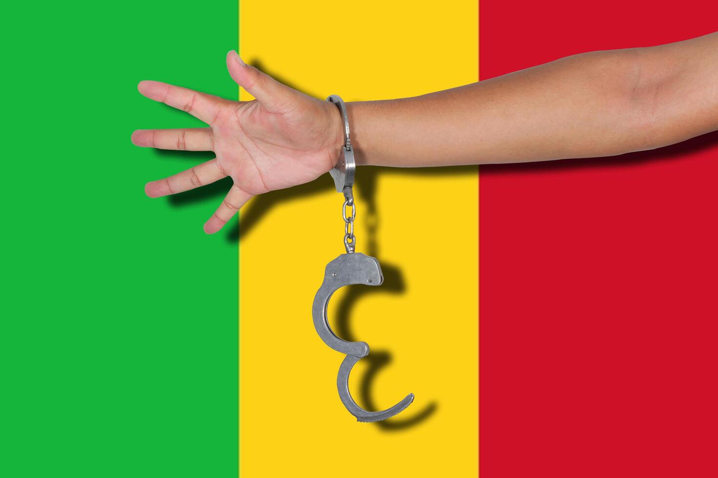 handboeien met hand op mali vlag foto